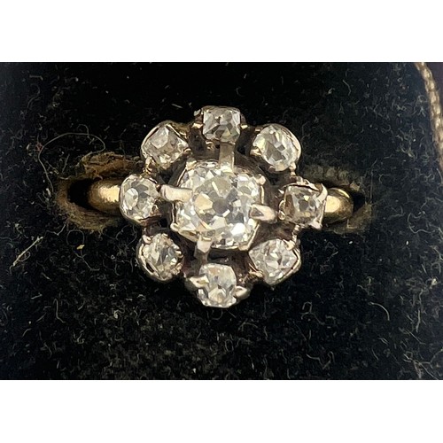 661 - A 19thC diamond set cluster ring in 18 carat yellow gold, comprising of a central four claw and grai... 