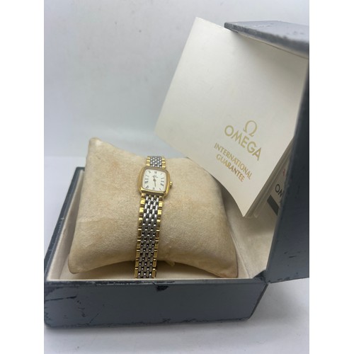 714 - An Omega De Ville ladies duo tone wristwatch. With original box and booklet.