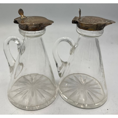 425 - A pair of glass and silver whisky noggins. Birmingham 1922. Maker Hukin & Heath Ltd. 10cm h.