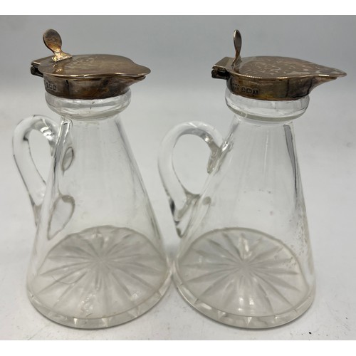 425 - A pair of glass and silver whisky noggins. Birmingham 1922. Maker Hukin & Heath Ltd. 10cm h.