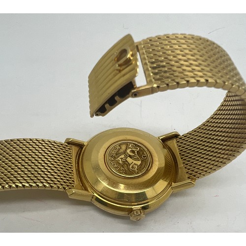 713 - An 18 carat gold gentleman’s Omega De Ville Seamaster wristwatch on 18ct gold bracelet with date ape... 