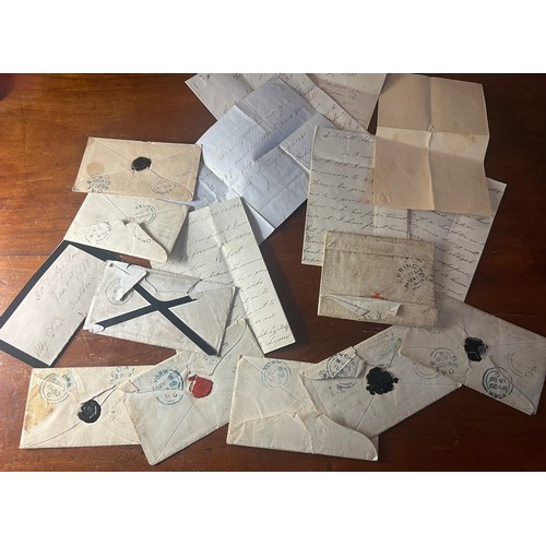 913 - A quantity of mid 19thC postal history to include envelopes and letters.