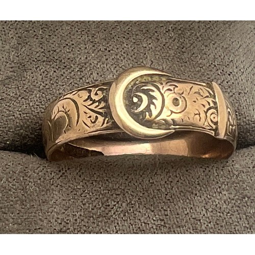 664 - A nine carat gold buckle ring size T. Weight 2.8gm.