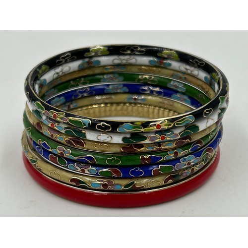 584 - Costume jewellery to include two Halcyon enamel bangles, a pair of UNOde50 Semi-long silver-plated e... 