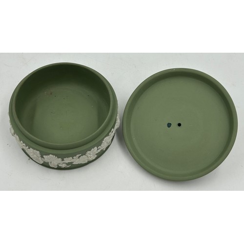 192 - A collection of Wedgwood green Jasperware to include lidded pot, various vases, a dark green twin ha... 