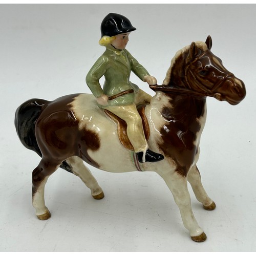 195 - A collection of ceramics to include a Beswick Girl on Skewbald Pony, model 1499, Beswick Parrot 930,... 