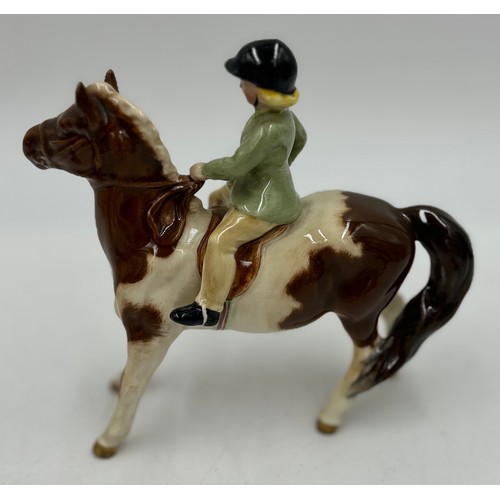 195 - A collection of ceramics to include a Beswick Girl on Skewbald Pony, model 1499, Beswick Parrot 930,... 