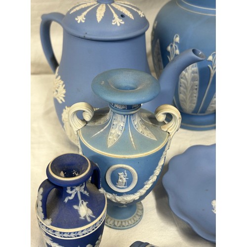 182 - A quantity of Wedgwood Jasperware, blue and dark blue to include a tall jug with lily of the valley ... 