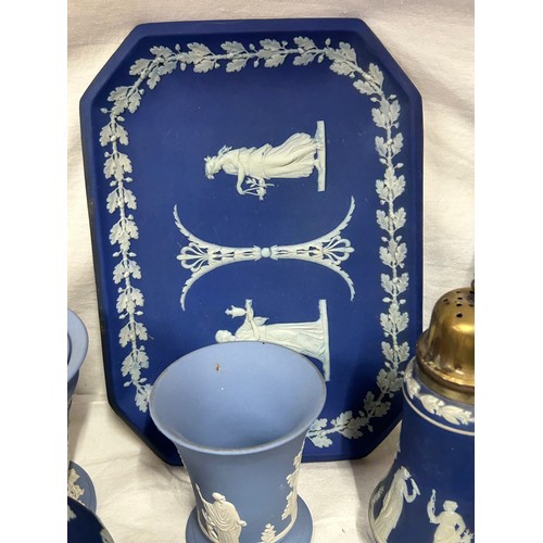 182 - A quantity of Wedgwood Jasperware, blue and dark blue to include a tall jug with lily of the valley ... 