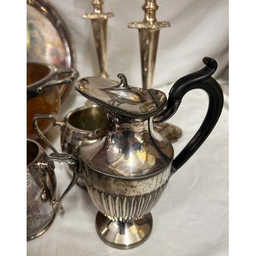 748 - A quantity of silver plated items to include a pair of candlesticks, 2 x coffee pots, teapot, sugar,... 