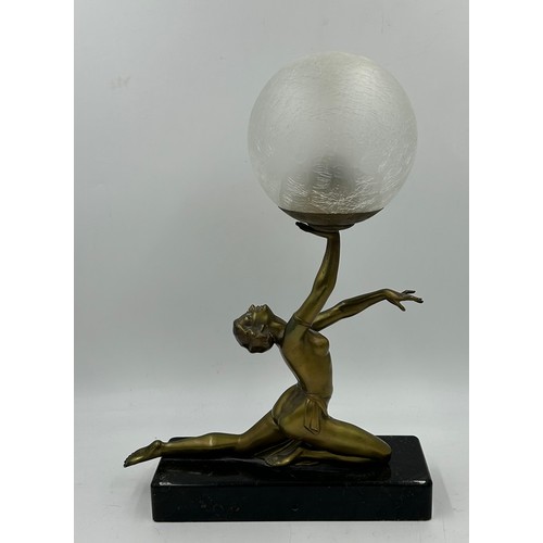 1012 - An Art Deco style figural table lamp, modelled in the form of a lady atop a marble type base. 47cm t... 