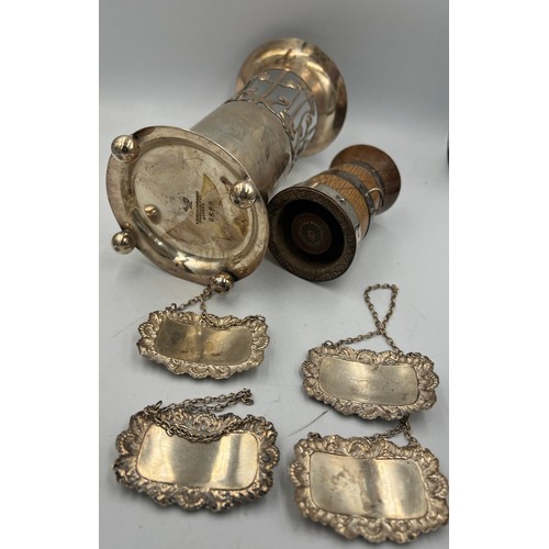 799 - Four silver decanter labels, silver bound oak pepper pot and a silver plated Art Nouveau vase.