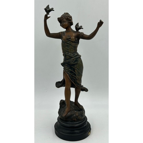 1303 - A late 19thC Spelter Figurine Charmeuse by R. Richard depicting a woman with two doves. 44cm h.