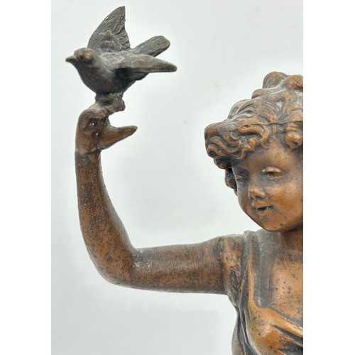 1303 - A late 19thC Spelter Figurine Charmeuse by R. Richard depicting a woman with two doves. 44cm h.