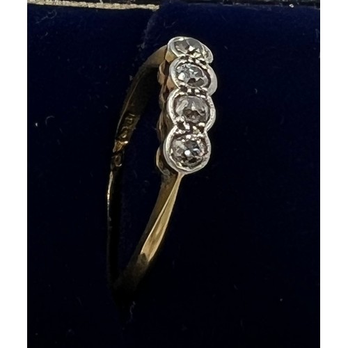 615 - An 18 carat gold and platinum ring set with 4 diamonds. Size L/M. Weight 2.3gm.