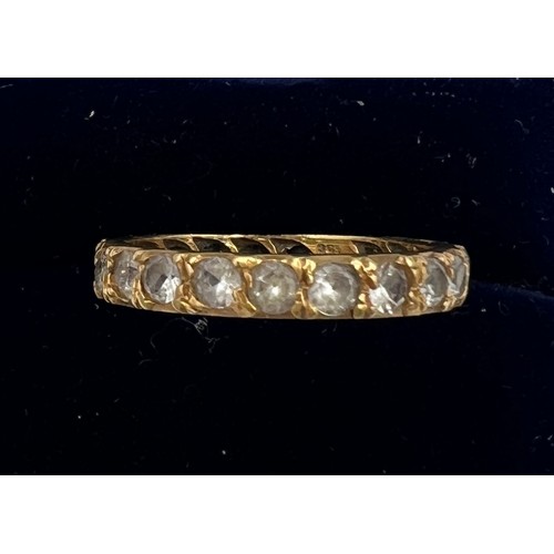 614 - An 18 carat gold ring set with clear stones, marked syn spin. Size N. Weight 2.8gm.