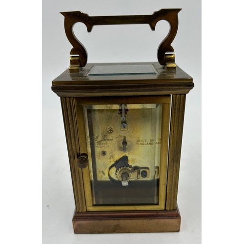 1002 - A Brass Mantle Carriage Clock with roman numeral dial with gilt case and bevelled glass windows surr... 