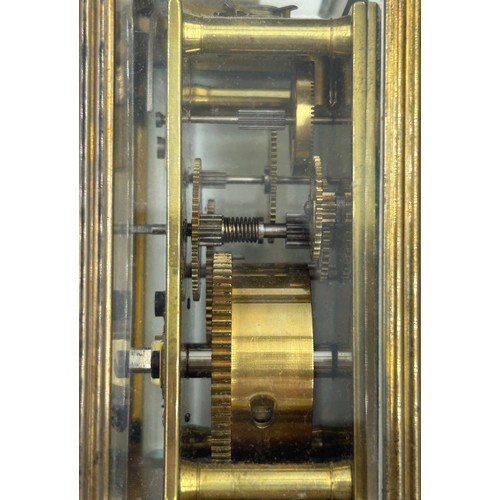 1002 - A Brass Mantle Carriage Clock with roman numeral dial with gilt case and bevelled glass windows surr... 