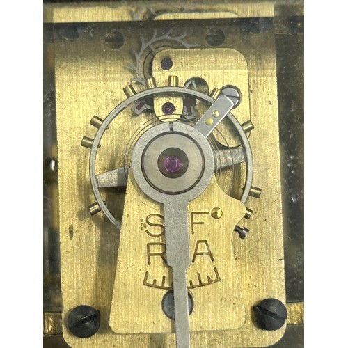 1002 - A Brass Mantle Carriage Clock with roman numeral dial with gilt case and bevelled glass windows surr... 