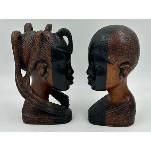 925 - A pair of mid 20thC Nigerian carved hard wood heads, one male one female. Both 26cm.