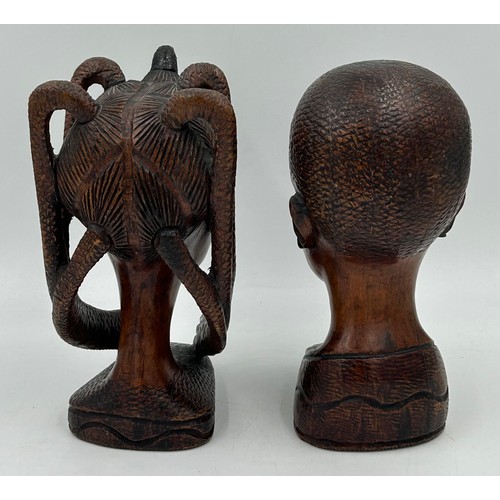 925 - A pair of mid 20thC Nigerian carved hard wood heads, one male one female. Both 26cm.