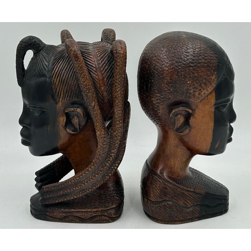 925 - A pair of mid 20thC Nigerian carved hard wood heads, one male one female. Both 26cm.