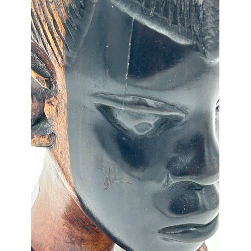 925 - A pair of mid 20thC Nigerian carved hard wood heads, one male one female. Both 26cm.