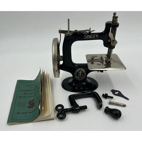 1307 - A Child's Singer Sewing Machine - 'A singer For The Girls. Teaches them to make clothes for their do... 