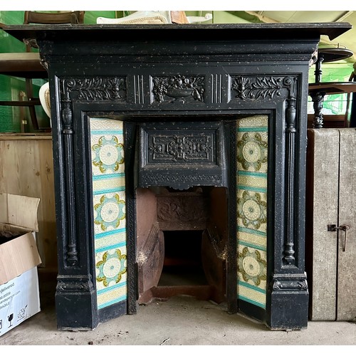 39 - A Victorian cast iron fireplace with tiled insert together with trivets, fender, early 20thC racehor... 