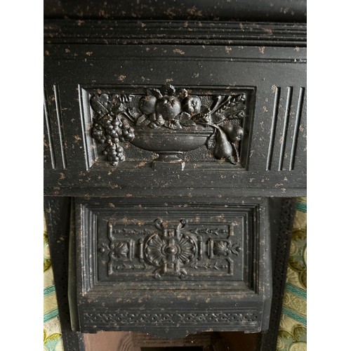 39 - A Victorian cast iron fireplace with tiled insert together with trivets, fender, early 20thC racehor... 