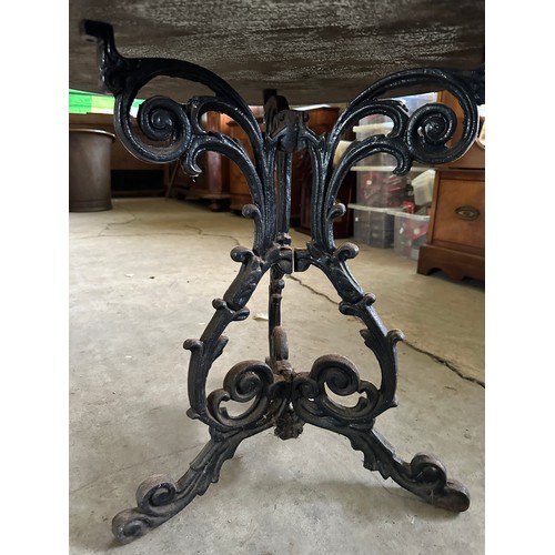 40 - A 19thC cast iron pub table with wooden circular top. 76cm d.