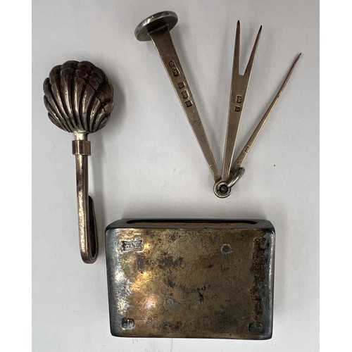 788 - Silver tobacco tamper Birmingham 1900, maker GE Walton & Co Ltd, silver napkin holder and a silver m... 