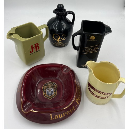 1353 - Four Whisky advertising jugs and a Laurent Perrier ashtray.