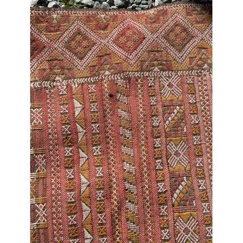 1219 - A hand woven wool rug approximately 170cm x 327cm.