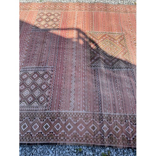 1218 - A large hand woven wool rug approximately 353cm x 234cm.