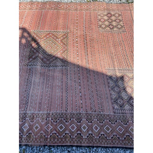 1218 - A large hand woven wool rug approximately 353cm x 234cm.