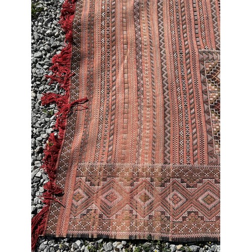 1218 - A large hand woven wool rug approximately 353cm x 234cm.