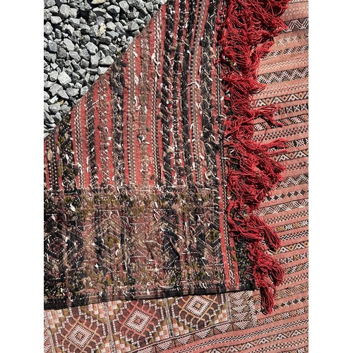 1218 - A large hand woven wool rug approximately 353cm x 234cm.