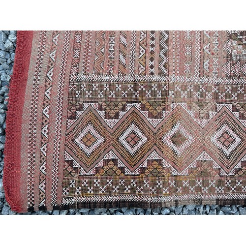 1218 - A large hand woven wool rug approximately 353cm x 234cm.