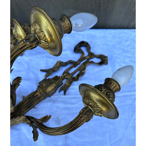 1015 - Two decorative three branch wall lights 54cm h together with two brass candelabras 42.5cm h. One loo... 