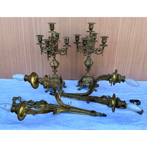 1015 - Two decorative three branch wall lights 54cm h together with two brass candelabras 42.5cm h. One loo... 