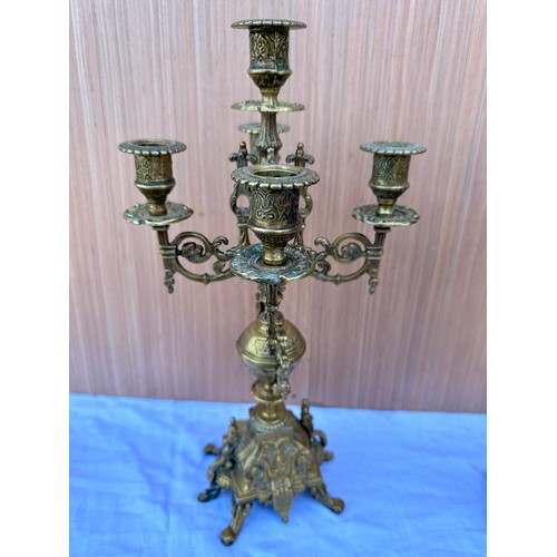 1015 - Two decorative three branch wall lights 54cm h together with two brass candelabras 42.5cm h. One loo... 