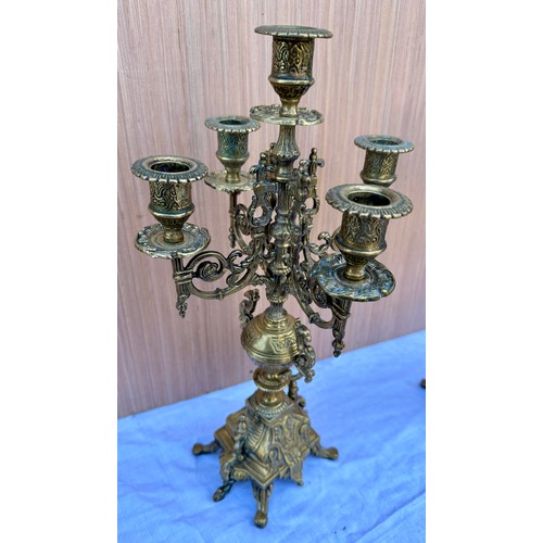 1015 - Two decorative three branch wall lights 54cm h together with two brass candelabras 42.5cm h. One loo... 