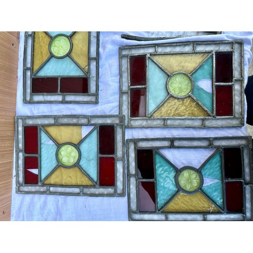 33 - A quantity of stained glass panels, to include a set of four matching with diamond shapes to centre,... 