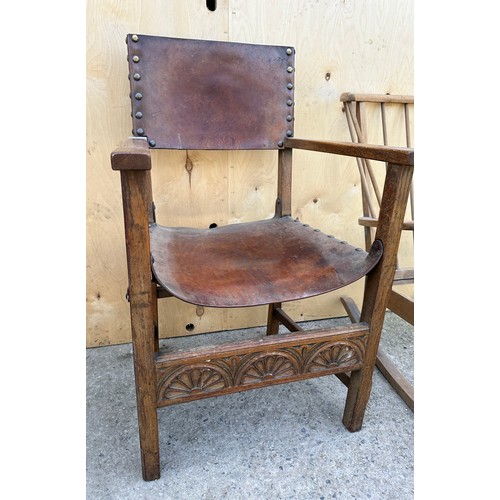 57 - Two chairs to include Ercol style mid century rocking chair and an oak leather seated carver chair.