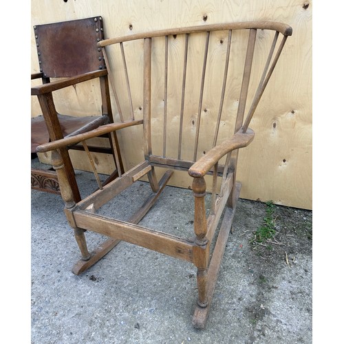 57 - Two chairs to include Ercol style mid century rocking chair and an oak leather seated carver chair.