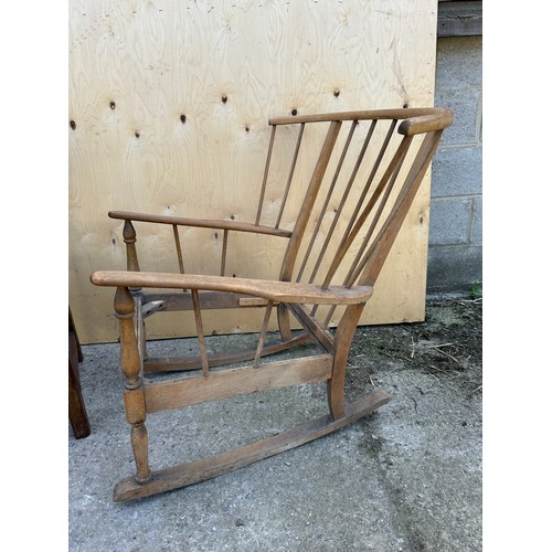 57 - Two chairs to include Ercol style mid century rocking chair and an oak leather seated carver chair.