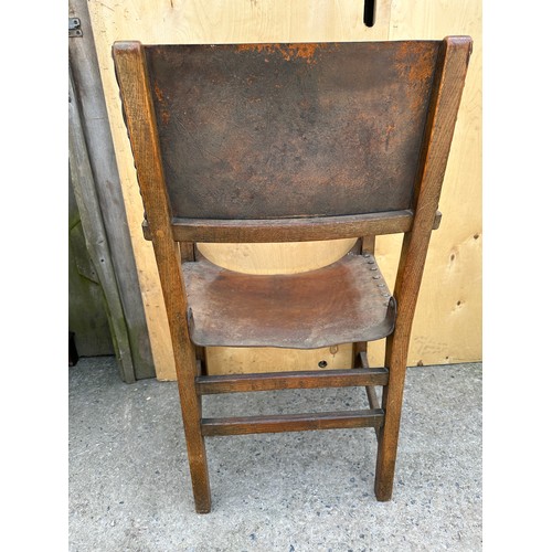 57 - Two chairs to include Ercol style mid century rocking chair and an oak leather seated carver chair.