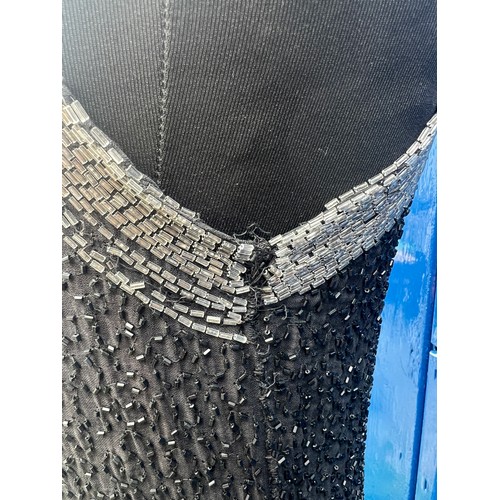 850 - A 1920’s beaded evening dress, label made in France, with black and clear bead decoration.  Underarm... 