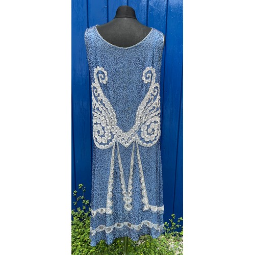 851 - A 1920’s beaded evening dress embellished with blue, silver, white and clear beads.